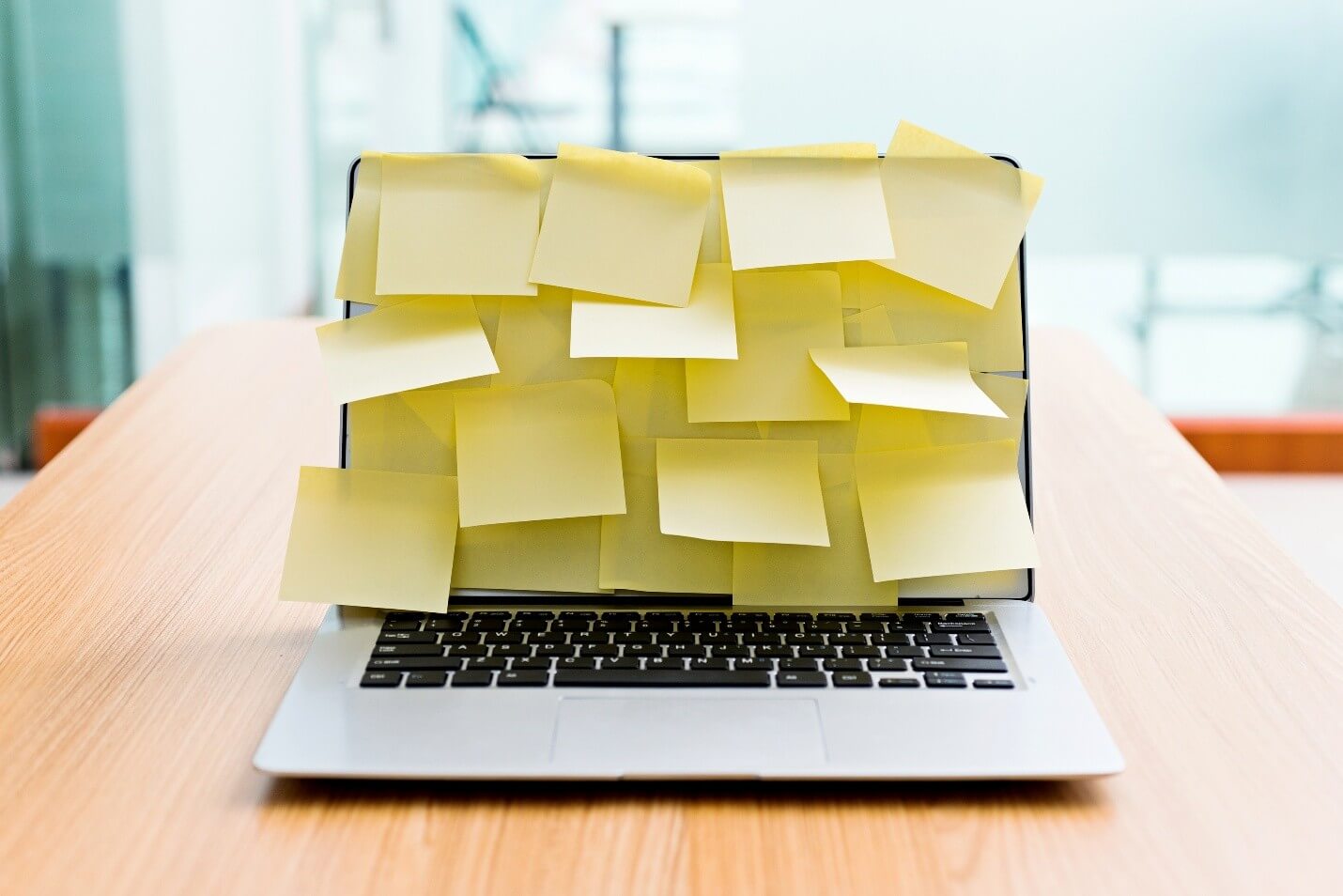 laptop covered with sticky notes