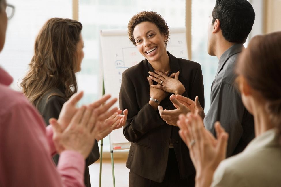 group of people clapping for one person