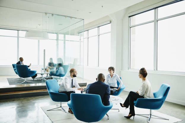 Four people in a circle talking